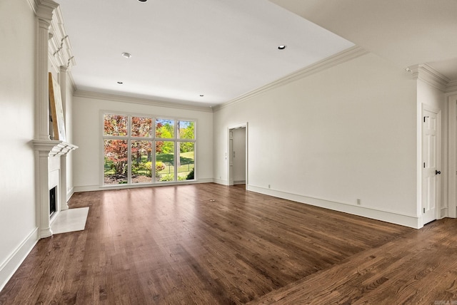 unfurnished living room featuring a fireplace with flush hearth, dark wood finished floors, crown molding, and baseboards