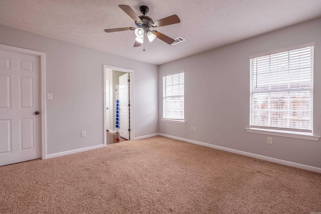 unfurnished bedroom with a ceiling fan, baseboards, and carpet floors