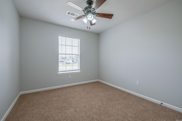 empty room featuring visible vents, carpet flooring, baseboards, and ceiling fan