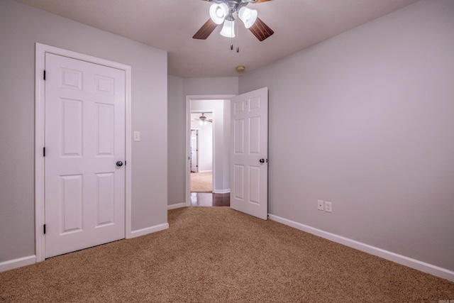 unfurnished bedroom with baseboards, a ceiling fan, and carpet flooring