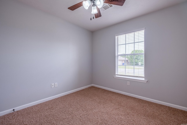 spare room featuring ceiling fan, baseboards, visible vents, and carpet