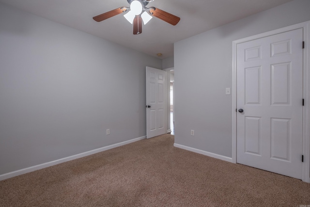 unfurnished bedroom featuring ceiling fan, baseboards, and carpet flooring