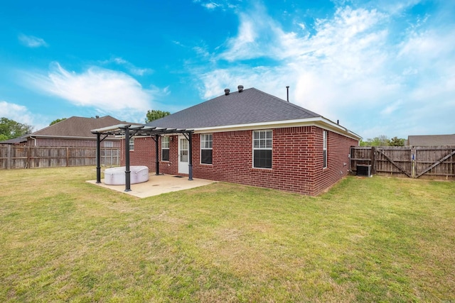 rear view of house with a pergola, a patio area, brick siding, and a fenced backyard