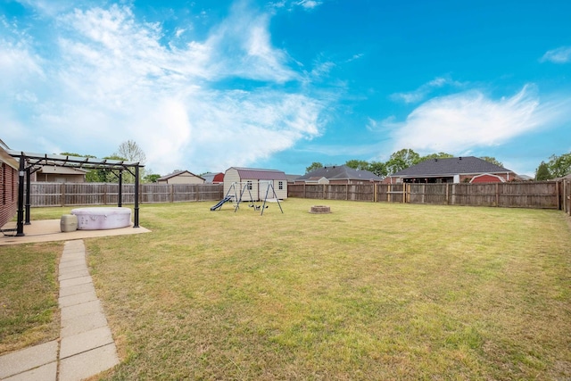 view of yard with a pergola, a patio area, a fenced backyard, and a playground