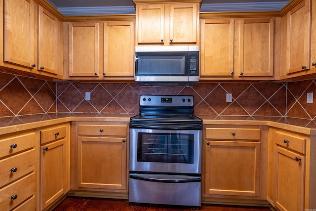 kitchen with decorative backsplash, tile countertops, and appliances with stainless steel finishes