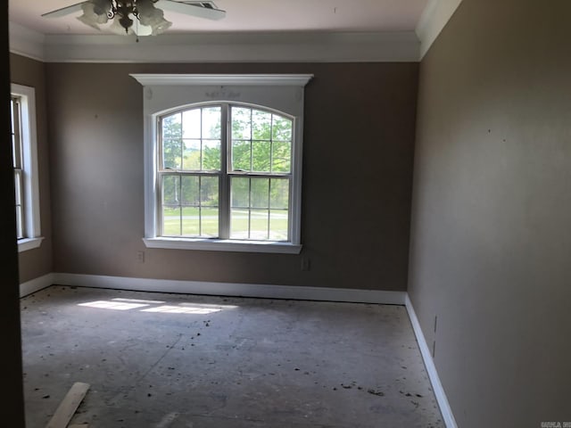 empty room featuring baseboards, ceiling fan, and crown molding