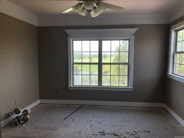 empty room featuring ceiling fan, a wealth of natural light, crown molding, and baseboards