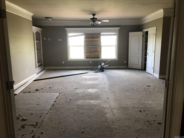 spare room with crown molding, baseboards, and a ceiling fan