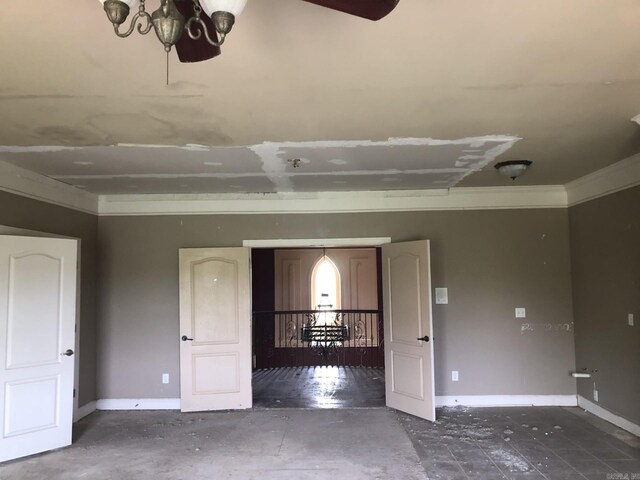 spare room with baseboards and crown molding