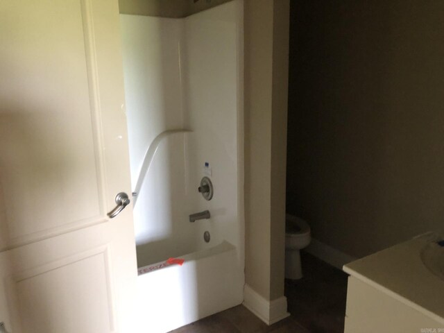 full bathroom featuring toilet, baseboards, shower / bath combination, tile patterned flooring, and vanity