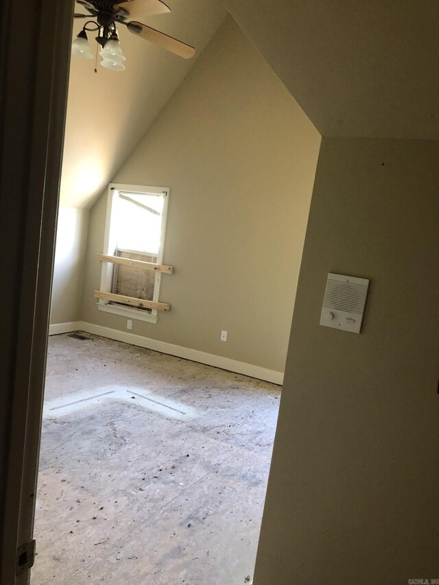 additional living space featuring ceiling fan, vaulted ceiling, and baseboards
