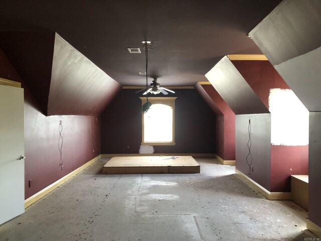 bonus room featuring baseboards, a ceiling fan, visible vents, and lofted ceiling