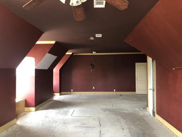 bonus room featuring lofted ceiling, a ceiling fan, visible vents, and baseboards