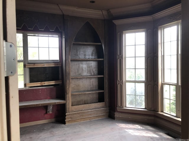 interior details with crown molding and baseboards