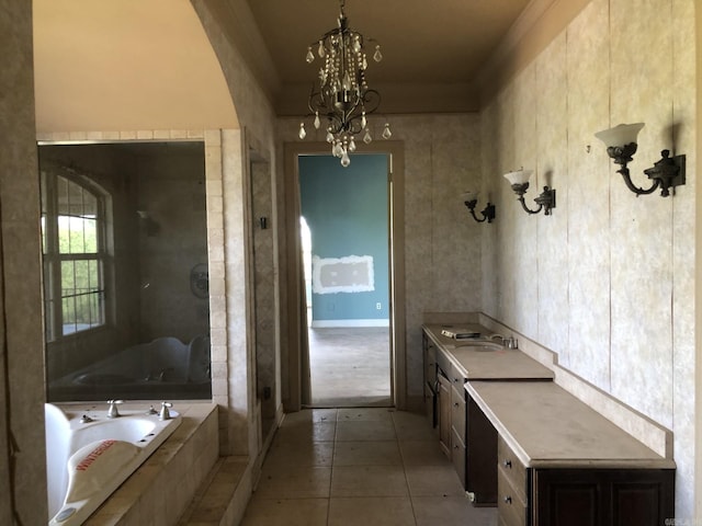full bathroom featuring a shower stall, tile patterned floors, a sink, a chandelier, and a garden tub