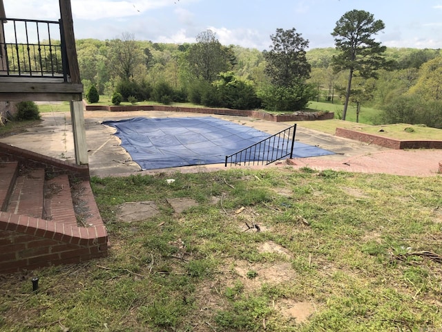 view of pool featuring a covered pool and a patio