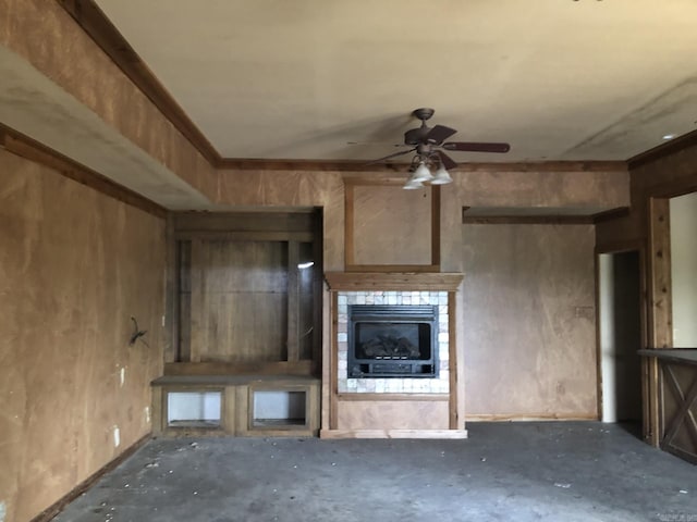 unfurnished living room featuring ceiling fan, a fireplace, and unfinished concrete floors