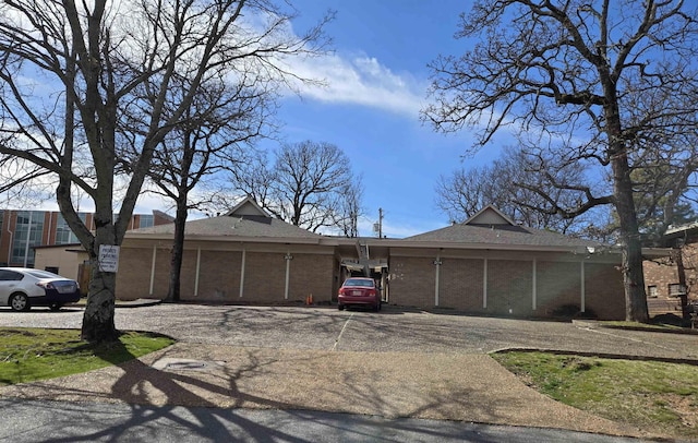 200 N Fillmore St, Little Rock, AR 72205 - view of front of house featuring driveway, brick siding, and roof with shingles