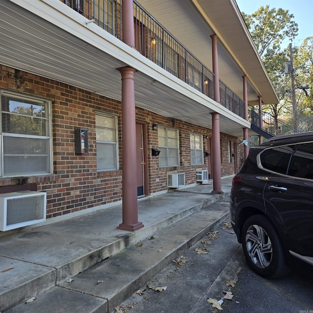 200 N Fillmore St, Little Rock, AR 72205 - view of property exterior with brick siding, cooling unit, and a balcony
