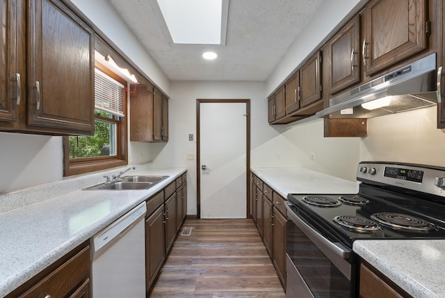 kitchen with a sink, electric range, white dishwasher, wood finished floors, and under cabinet range hood