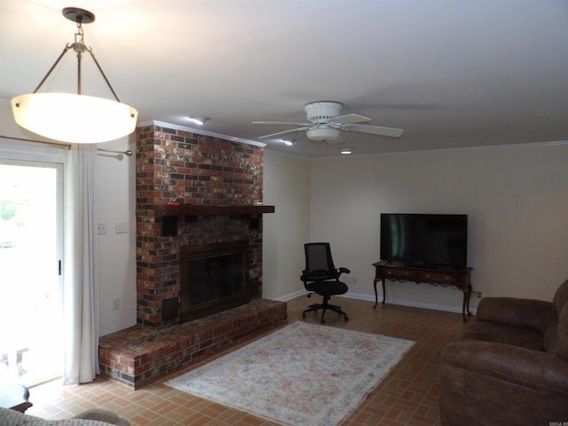 living area with a fireplace, brick floor, a ceiling fan, and baseboards