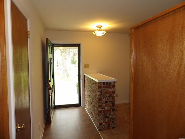 doorway to outside with baseboards