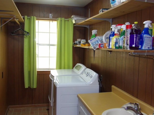 laundry room with washing machine and dryer, a wealth of natural light, a sink, and laundry area