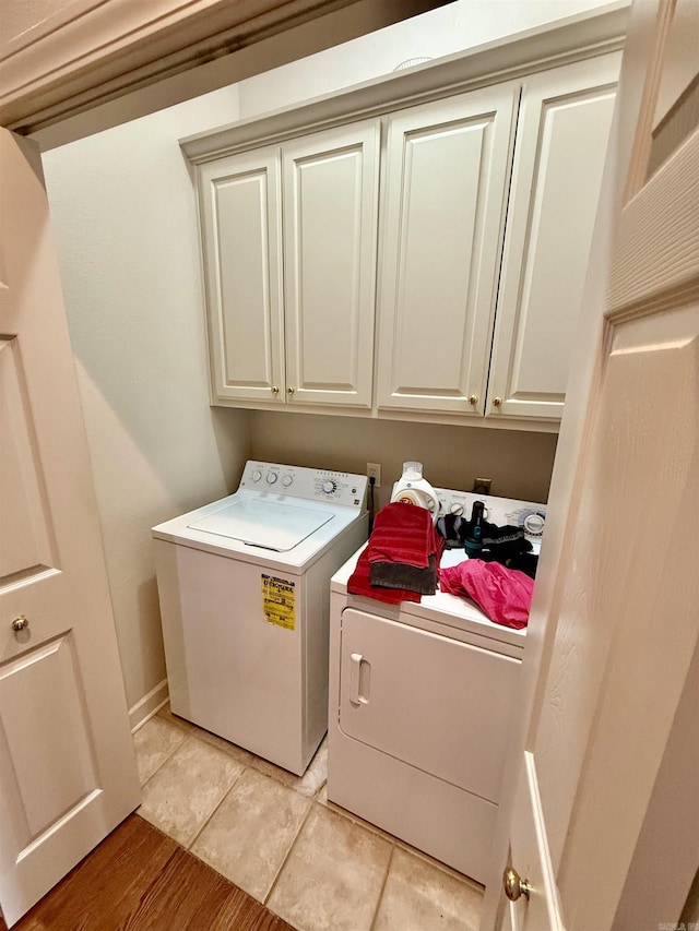 2308 Saxony Blvd, Searcy, AR 72143 - clothes washing area featuring cabinet space, independent washer and dryer, and light tile patterned floors