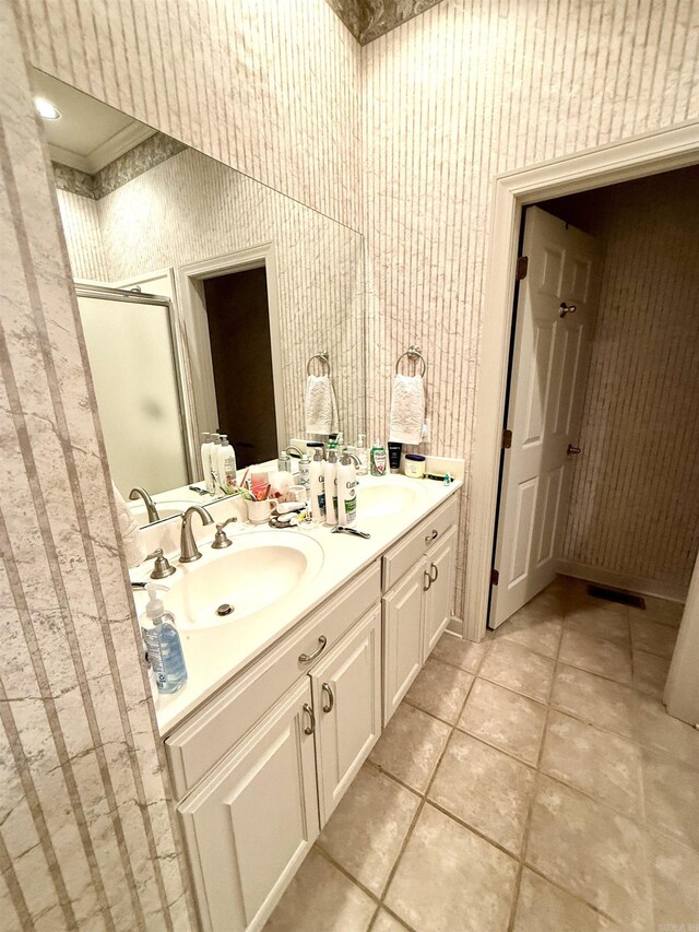 2308 Saxony Blvd, Searcy, AR 72143 - full bathroom with wallpapered walls, a sink, double vanity, and a stall shower