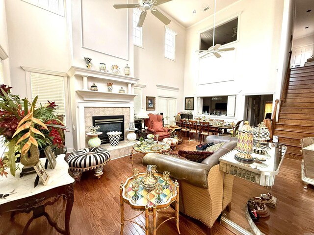 2308 Saxony Blvd, Searcy, AR 72143 - living room with a ceiling fan, stairs, wood finished floors, a towering ceiling, and a fireplace