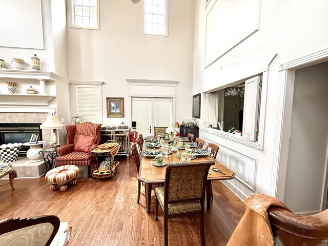 2308 Saxony Blvd, Searcy, AR 72143 - dining room with wood finished floors, a high ceiling, and a tile fireplace