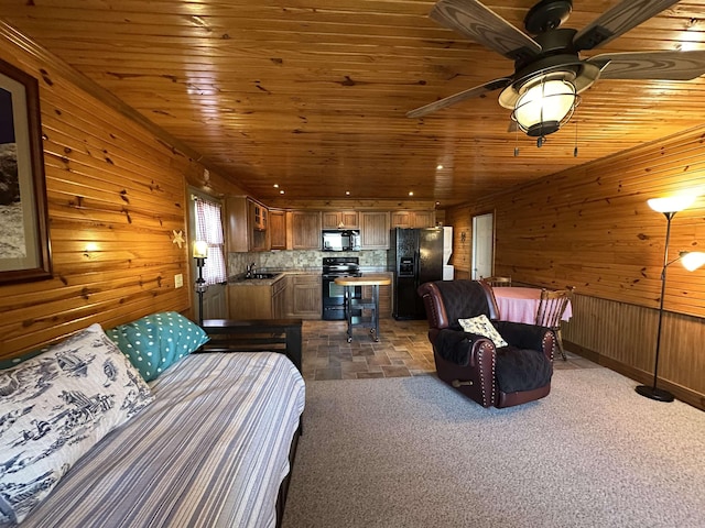 bedroom featuring a sink, wooden walls, black refrigerator with ice dispenser, and wood ceiling