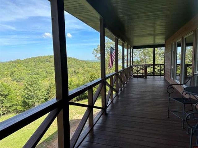 wooden deck featuring a view of trees