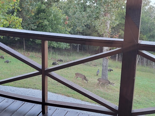 view of gate with a lawn