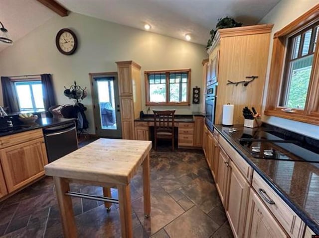 kitchen featuring lofted ceiling with beams, black appliances, a sink, and a wealth of natural light