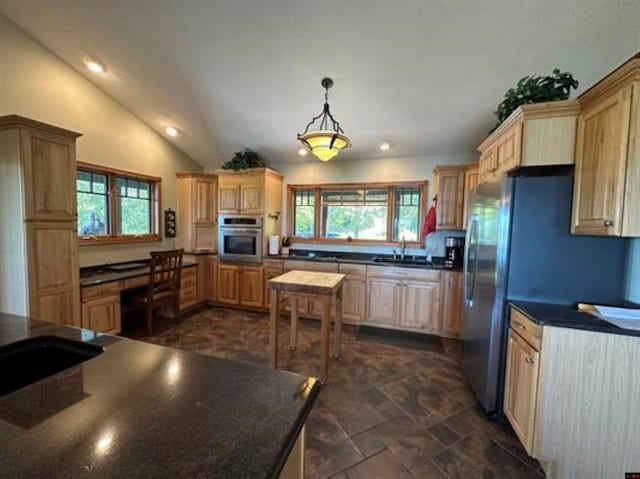kitchen with dark countertops, oven, recessed lighting, vaulted ceiling, and decorative light fixtures