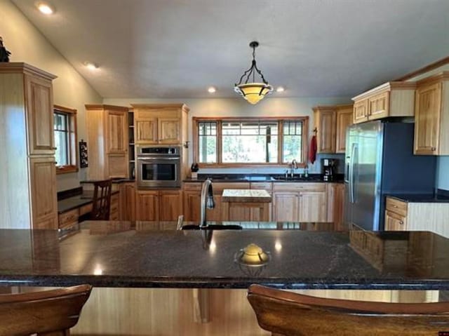 kitchen with dark countertops, stainless steel appliances, and a sink