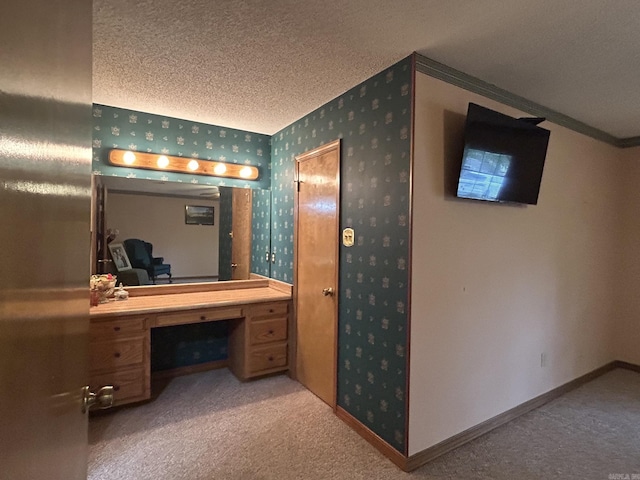 bathroom with wallpapered walls, a textured ceiling, crown molding, and baseboards