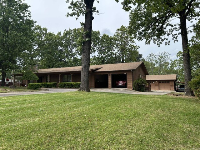 ranch-style home with an attached garage, a front lawn, and concrete driveway