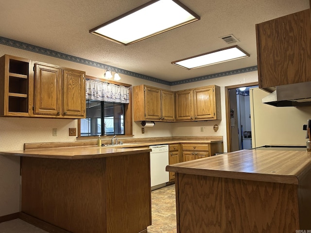 kitchen with white dishwasher, butcher block countertops, a textured ceiling, a peninsula, and visible vents