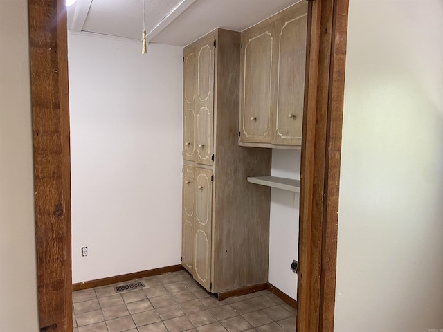 washroom featuring attic access, visible vents, baseboards, and light tile patterned floors
