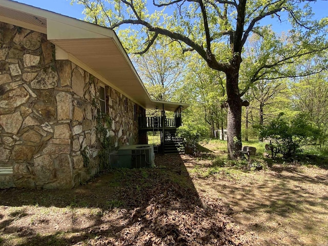 view of yard featuring central AC and stairs
