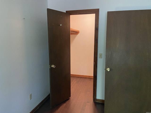 unfurnished bedroom featuring baseboards and wood finished floors