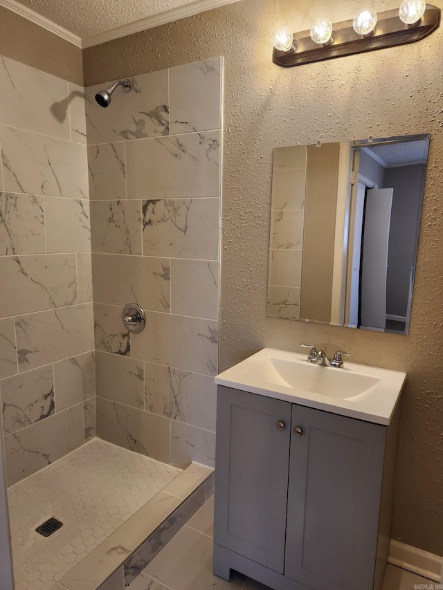 bathroom with a textured ceiling, a stall shower, crown molding, a textured wall, and vanity