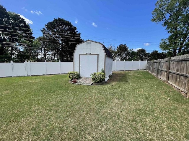 view of yard featuring a fenced backyard, an outbuilding, and a storage unit