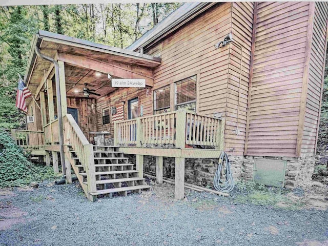 deck featuring stairs and ceiling fan