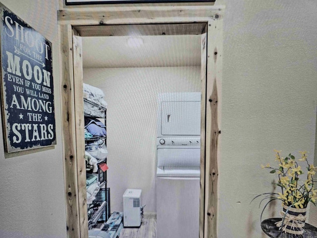 clothes washing area with wood finished floors