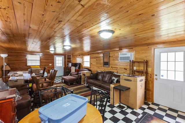 living area with wooden walls, tile patterned floors, and wood ceiling
