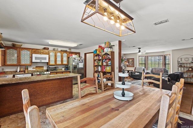 dining room featuring a toaster and visible vents