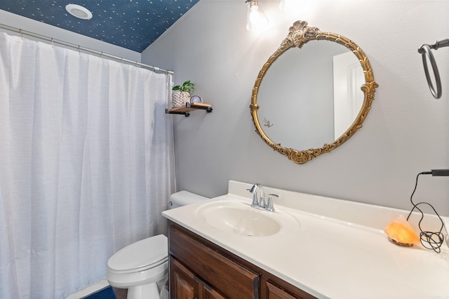 full bathroom featuring toilet, vanity, and a shower with shower curtain